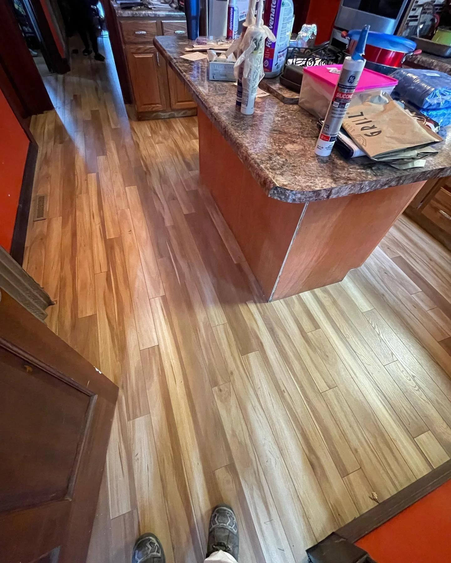 Warm wood-look kitchen flooring and updated cabinetry