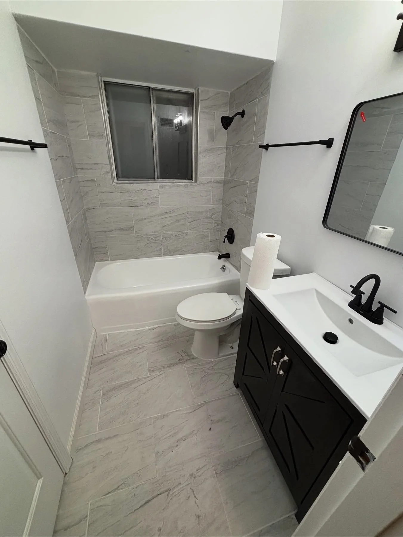 Finished shower with light marble-look wall tile